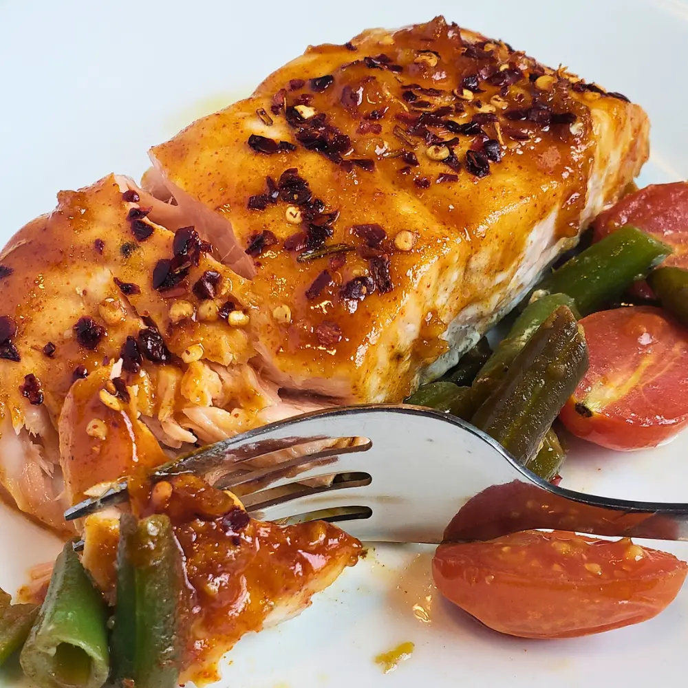 Balsamic Glazed Salmon fillet with a glossy date syrup glaze and a lemon slice.