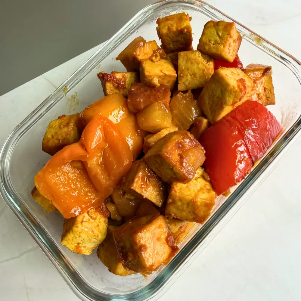 Golden tofu cubes glazed with date syrup and served with roasted pineapple and blistered cherry tomatoes by The Promised Cook