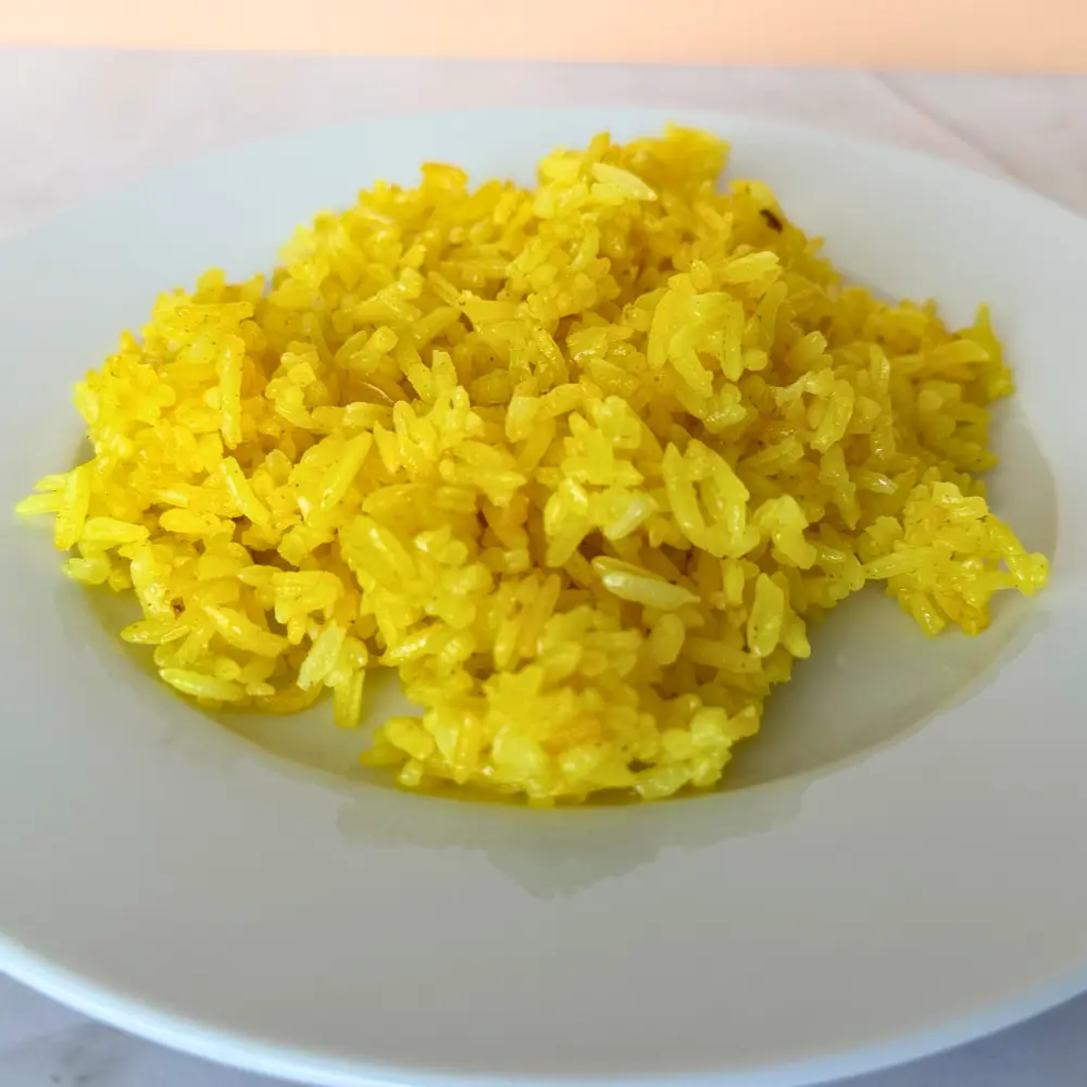A plate of fluffy Mediterranean yellow Basmati rice by The Promised Cook.