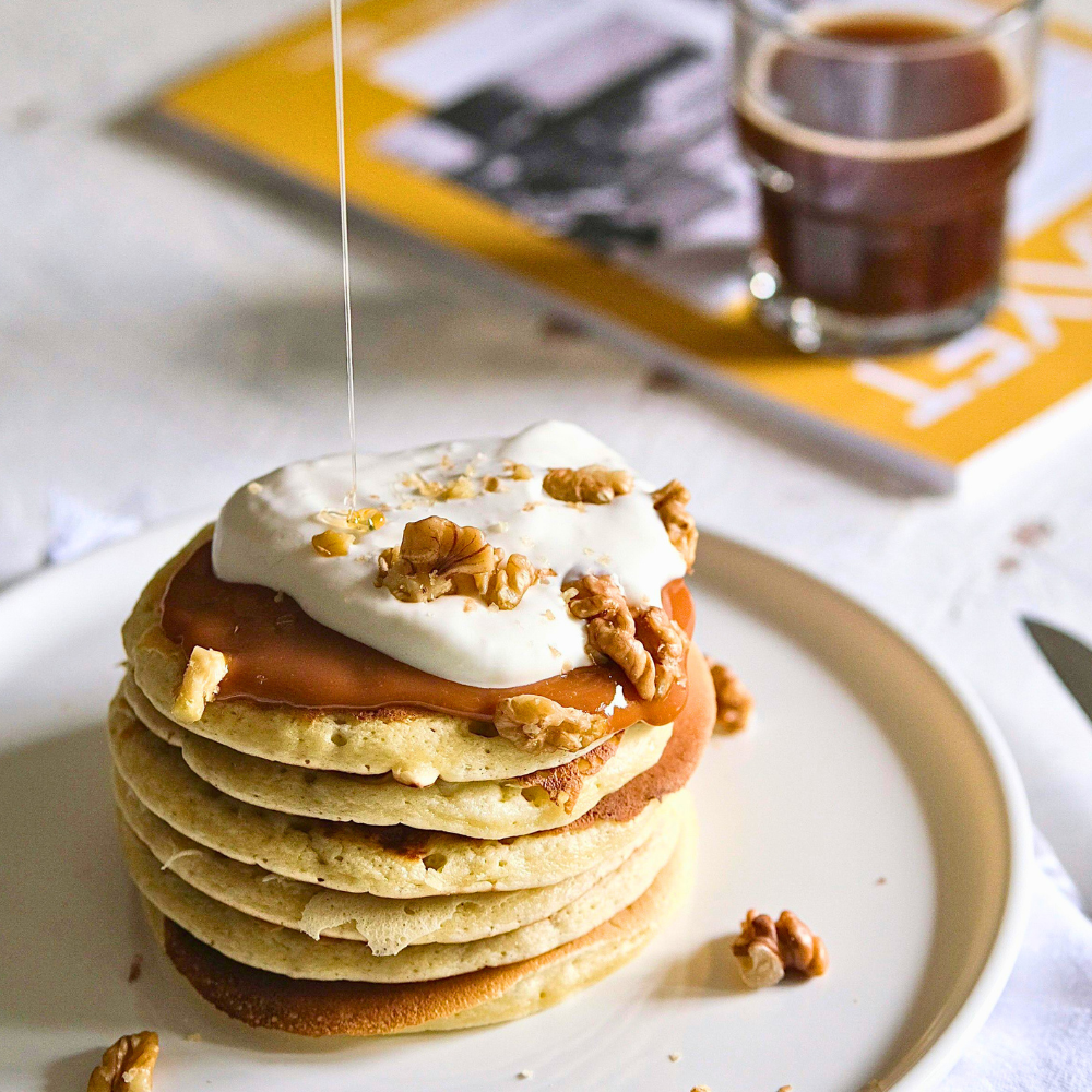 Stack of healthy pancakes drizzled with pure raw honey as a natural sweetener alternative for sugar-free baking